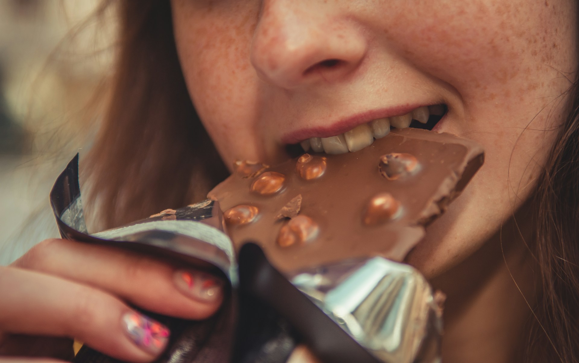 Smiling eating a chocolate bar