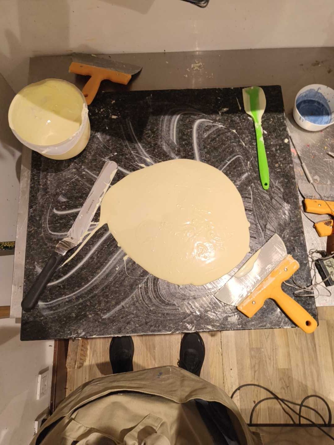 White chocolate being tempered on a marble slab